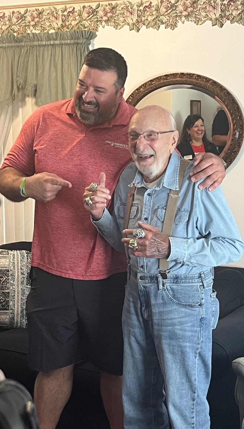 Former New England Patriot and three-time Super Bowl champion Joe Andruzzi met up with and delivered groceries to Rudy Longo, a 91-year-old leukemia and prostate cancer patient, to his Stratham house Wednesday, Sept. 13, 2023. Longo is seen wearing Andruzzi's Super Bowl rings.