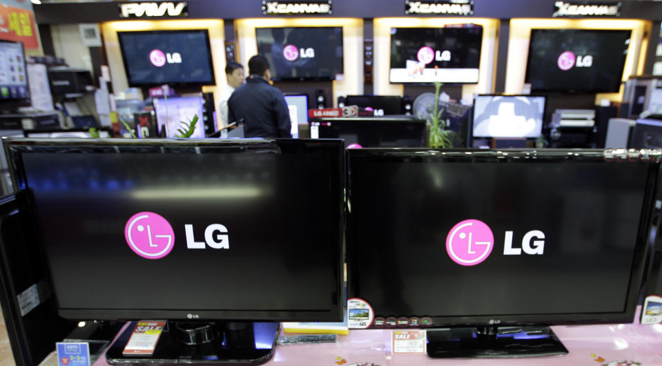 South Korean customers look at the LG electronics' TV products which made with LG Display panels at a Yongsan Electronic shop in Seoul, South Korea, Tuesday, April 24, 2012. LG Display Co., the world's second-largest maker of liquid crystal displays, Tuesday reported its third straight quarterly loss due to feeble demand for TVs. (AP Photo/Lee Jin-man)