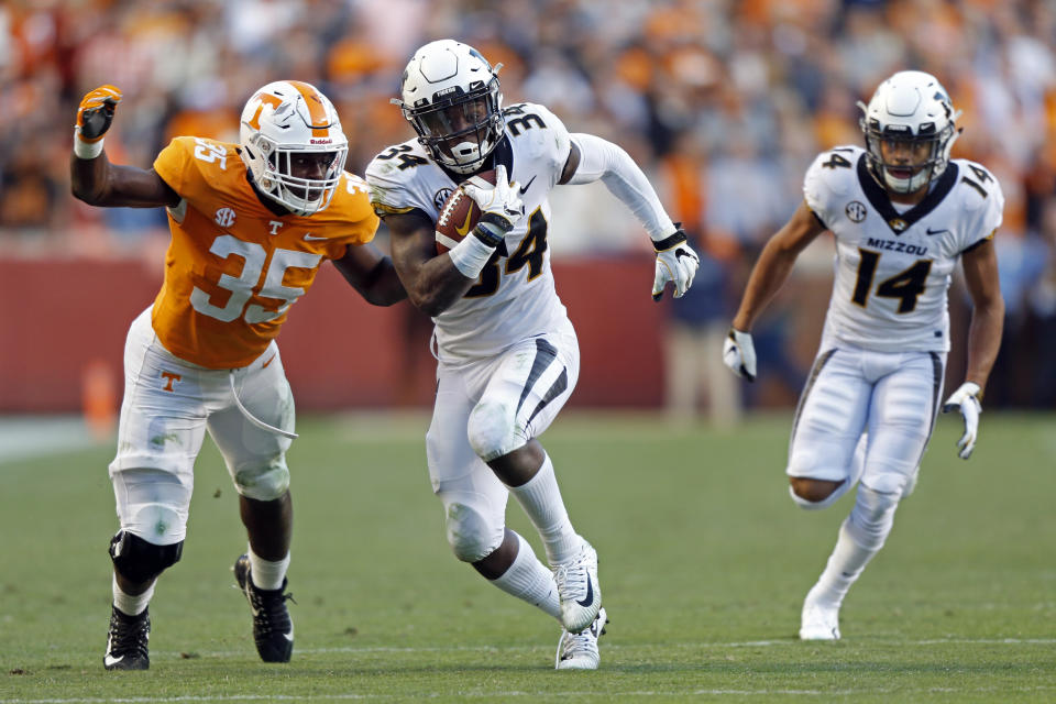 Missouri running back Larry Rountree III (34) runs for yardage as he's chased by Tennessee linebacker Daniel Bituli (35) in the first half of an NCAA college football game Saturday, Nov. 17, 2018, in Knoxville, Tenn. (AP Photo/Wade Payne)