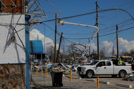 Crews work to repair power lines downed by Hurricane Michael in Springfield, Florida, U.S., October 16, 2018. REUTERS/Brian Snyder