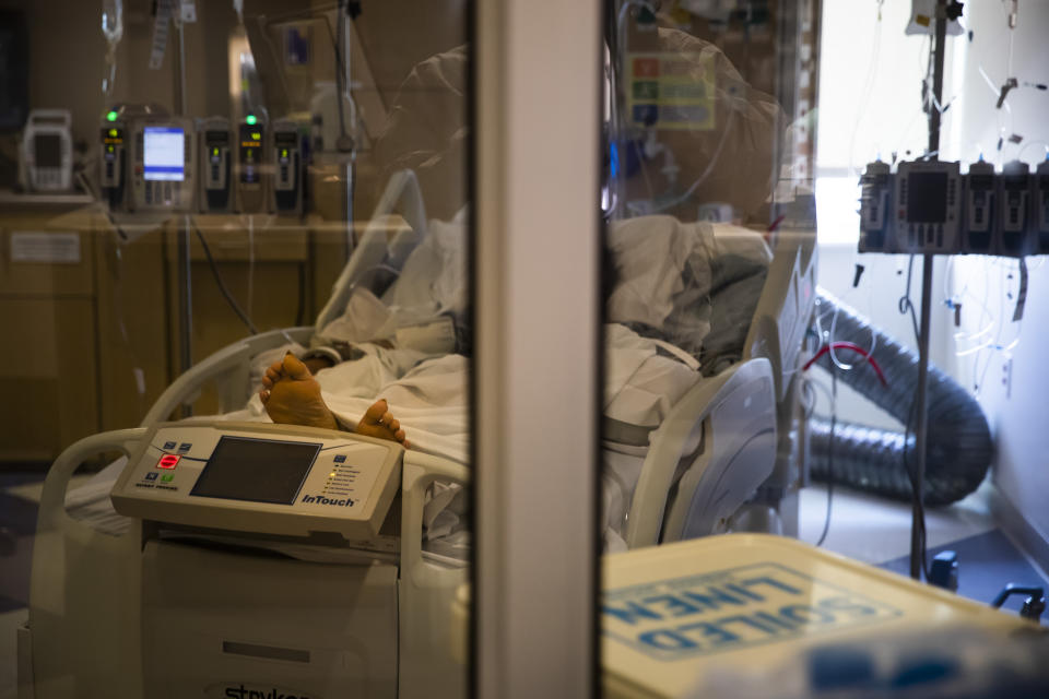 A COVID-19 patient lies in a bed in El Centro Regional Medical Center's COVID-19 unit in El Centro, Calif., Tuesday, July 21, 2020. (AP Photo/Jae C. Hong)