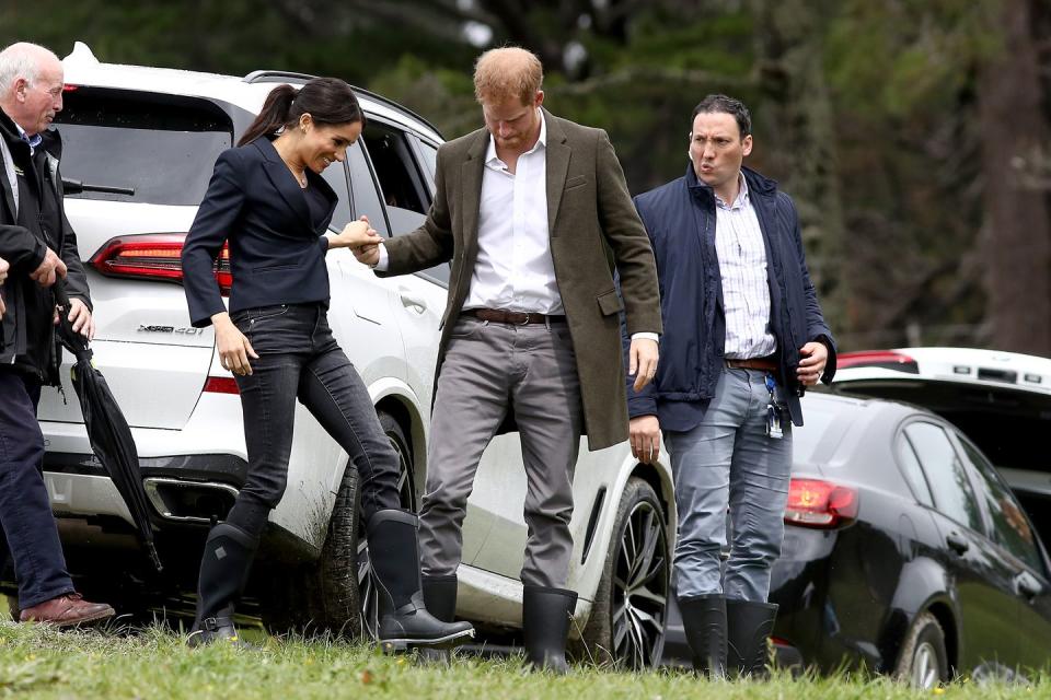 Prince Harry lends Meghan Markle a hand as they arrive the unveiling of The Queen's Commonwealth Canopy.