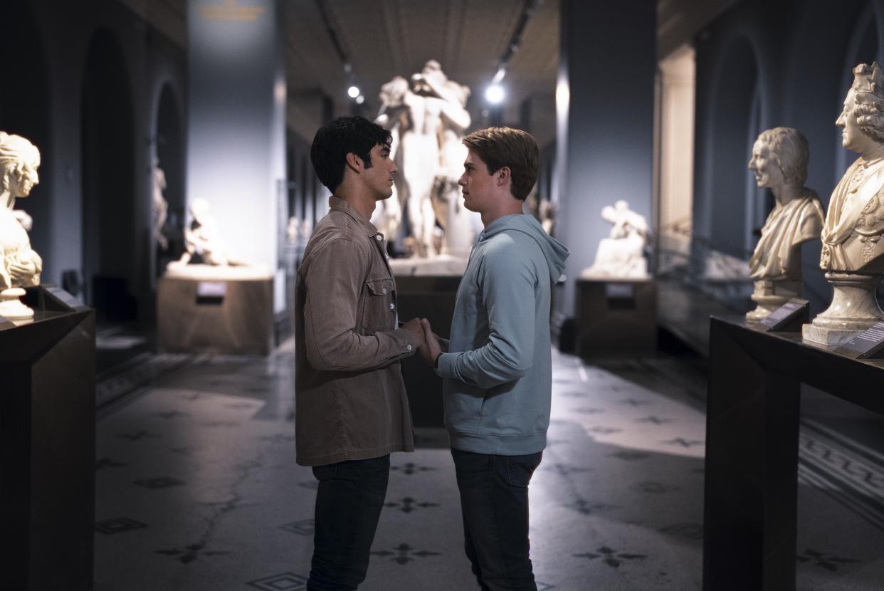  A scene from Red, White & Royal Blue showing Alex (Taylor Zakhar Perez) and Henry (Nicholas Galitzine) holding hands in the V&A Museum after-hours 