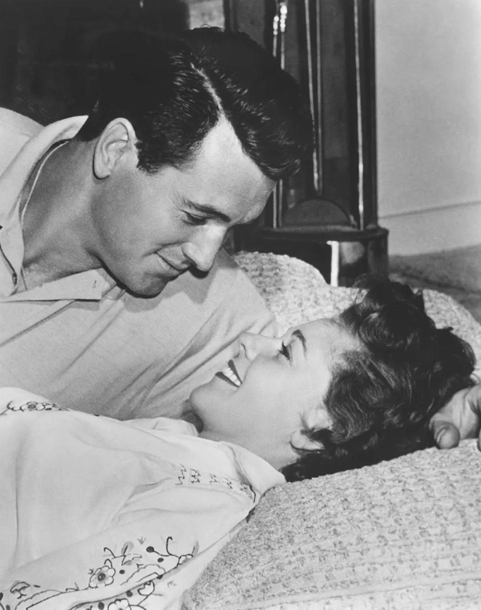 Rock Hudson looking at his wife Phyllis Gates in bed