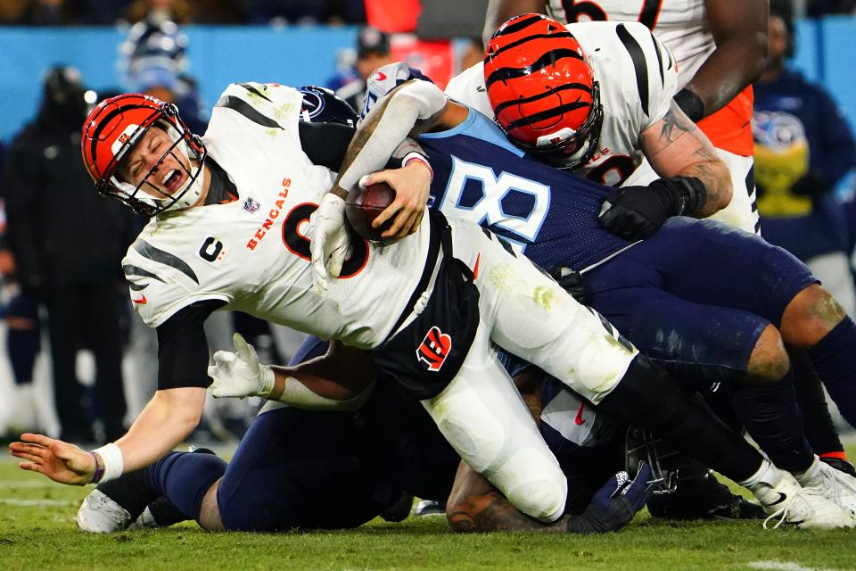 Cincinnati Bengals quarterback Joe Burrow (9) is sacked in the fourth quarter during an NFL divisional playoff football game against the Tennessee Titans, Saturday, Jan. 22, 2022, at Nissan Stadium in Nashville. The Cincinnati Bengals defeated the Tennessee Titans, 19-16, to advance to the AFC Championship game. 