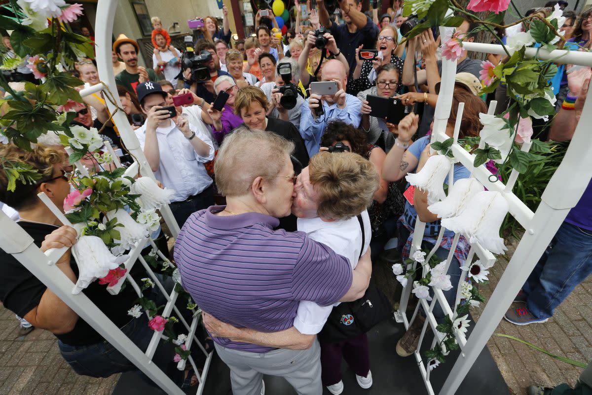 Ann Sorrell, 78, left, and Marge Eide, 77, of Ann Arbor, a couple for 43 years, embrace after exchanging vows in Ann Arbor, Mich., following a ruling by the US Supreme Court that struck down bans on same sex marriage nation wide Friday, June 26, 2015.