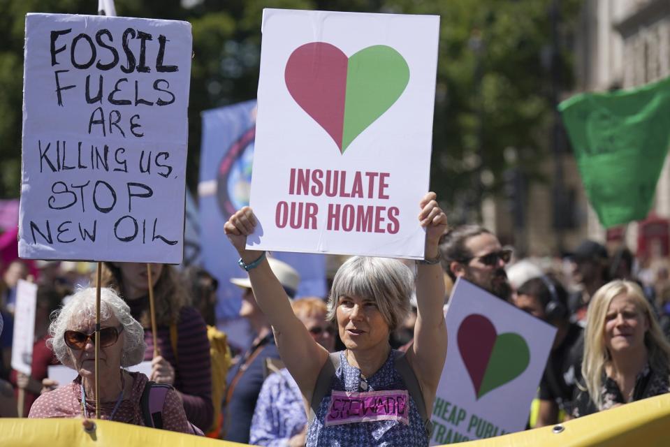 Members of environmental groups including Just Stop Oil, the Peace and Justice Project and Insulate Britain take part in a mass protest in Parliament Square, London. (Jonathan Brady/PA via AP)