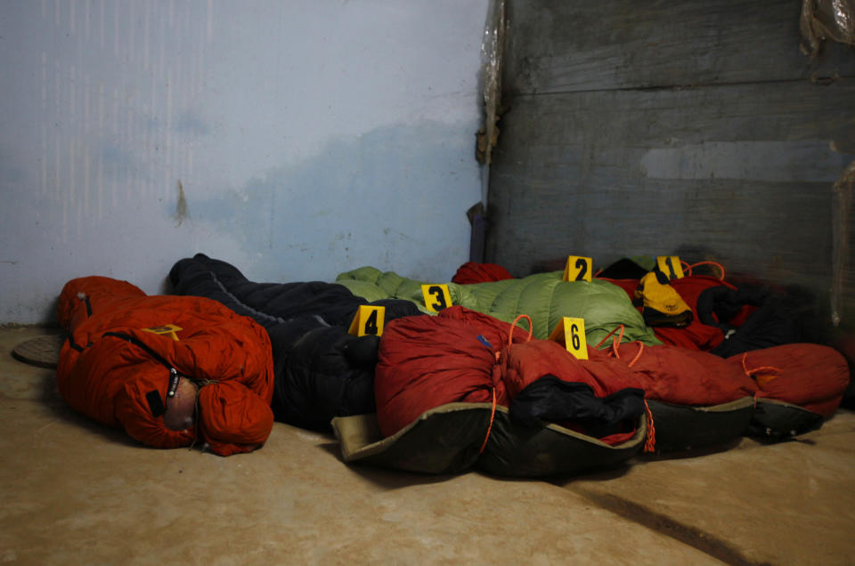 Bodies of climbers killed in an avalanche at Mount Manaslu lie covered with numbers at the Tribhuvan University Teaching hospital in Katmandu, Nepal, Monday, Sept. 24, 2012. Rescue helicopters flew over the high slopes of a northern Nepal peak again Monday to search for climbers lost in an avalanche that killed at least nine mountaineers and injured others. Many of the climbers were French, German and Italian. (AP Photo/Niranjan Shrestha)