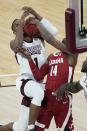 Mississippi State guard Iverson Molinar (1) has the ball stripped away by Alabama guard Keon Ellis (14) during the first half of an NCAA college basketball game in Starkville, Miss., Saturday, Feb. 27, 2021. (AP Photo/Rogelio V. Solis)