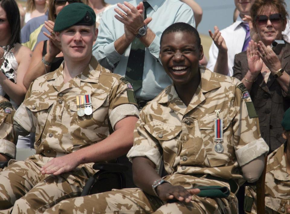 Mark Ormrod, 24 and Ben McBean, 21, smile as their comrades march past during a parade at the 40 Commando Royal Marines Operation Herrick 7 Medal Parade (Getty Images)