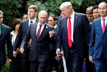U.S. President Donald Trump and Russia's President Vladimir Putin talk during the family photo session at the APEC Summit in Danang, Vietnam November 11, 2017. REUTERS/Jorge Silva