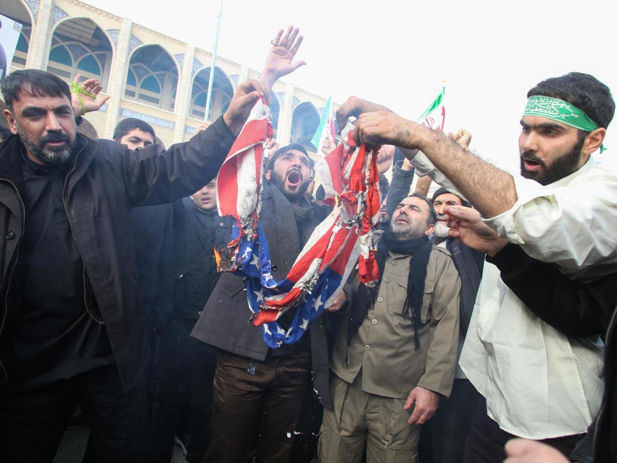 Iranians burn a US flag during a demonstration against American "crimes" in Tehran on 3 January, 2020 following the killing of Iranian Revolutionary Guards Major General Qasem Soleimani in a US strike on his convoy at Baghdad international airport: (2020 Getty Images)