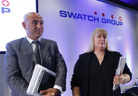 Nayla Hayek (R) Swatch Group Chair of the Board and her son Marc Hayek, CEO of watchmaker Breguet, listens to a journalist after the Swiss watch maker annual news conference in Plan-Les-Ouates near Geneva March 20, 2014. REUTERS/Denis Balibouse