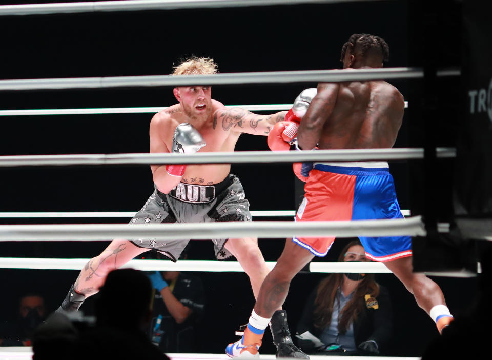 LOS ANGELES, CALIFORNIA - NOVEMBER 28: Jake Paul throws a punch against Nate Robinson in the first round during Mike Tyson vs Roy Jones Jr. presented by Triller at Staples Center on November 28, 2020 in Los Angeles, California. (Photo by Joe Scarnici/Getty Images for Triller)