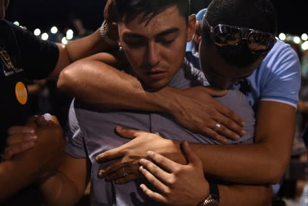 People gather for a vigil a day after a mass shooting in El Paso