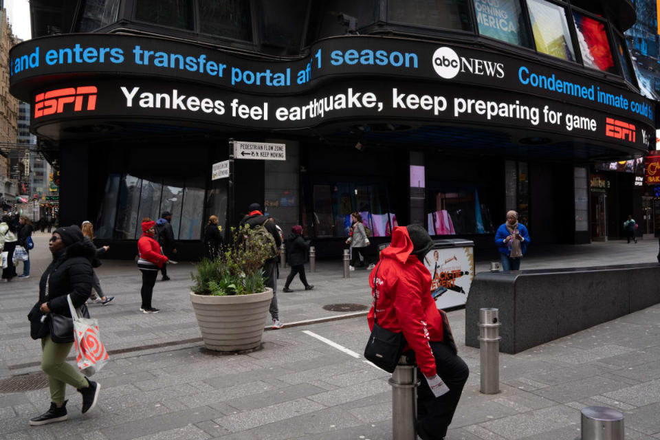 A photo of a digital ticker tape board at Times Square, displaying the news of a 4.8 magnitude earthquake on April 5, 2024 in New York City.