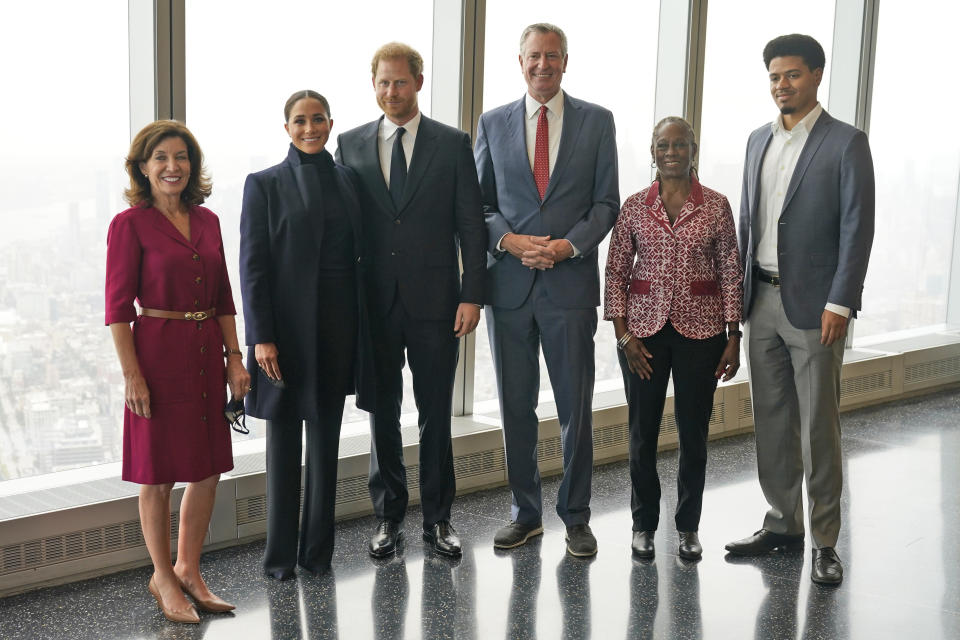 Meghan Markle, second from left, and Prince Harry, third from left, pose for pictures with New York governor Kathy Hochul, left, New York City mayor Bill de Blasio, third from right, first lady Chirlane McCray, second from right, and her son Dante de Blasio at the observatory in One World Trade in New York, Thursday, Sept. 23, 2021. (AP Photo/Seth Wenig)