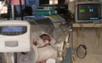 A newborn baby receives oxygen in an incubator in the intensive care unit of the Women's Hospital maternity ward in La Paz, Bolivia, Thursday, Aug. 13, 2020. Doctors say the supply of oxygen for the babies is becoming scarce, the result of nationwide blockades by supporters of the party of former President Evo Morales who object to the recent postponement of elections. Bolivia's political and social crisis is coinciding with the continued spread of the new coronavirus. (AP Photo/Juan Karita)