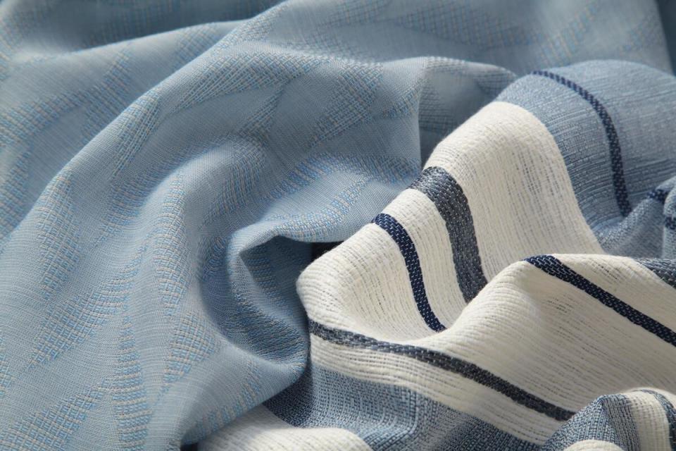 Drapery fabric from Pindler’s Exclusive Platinum indoor/outdoor collection, including Peniche in Chambray and Ibiza in Ink 