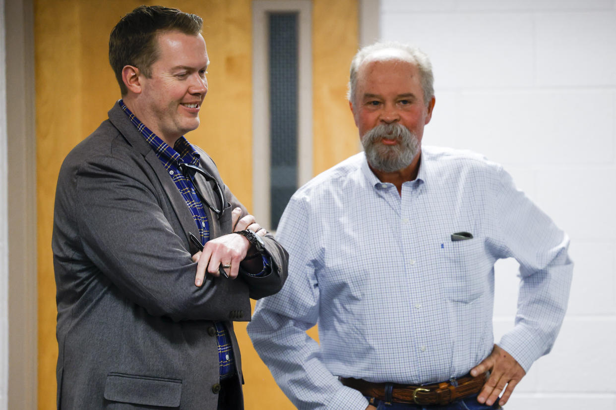 Woodland Park School Board Vice President David Illingworth II, left, and Director Mick Bates talk before the Board of Education meeting on April 12, 2023 in Woodland Park, Colo. (Michael Ciaglo for NBC News)