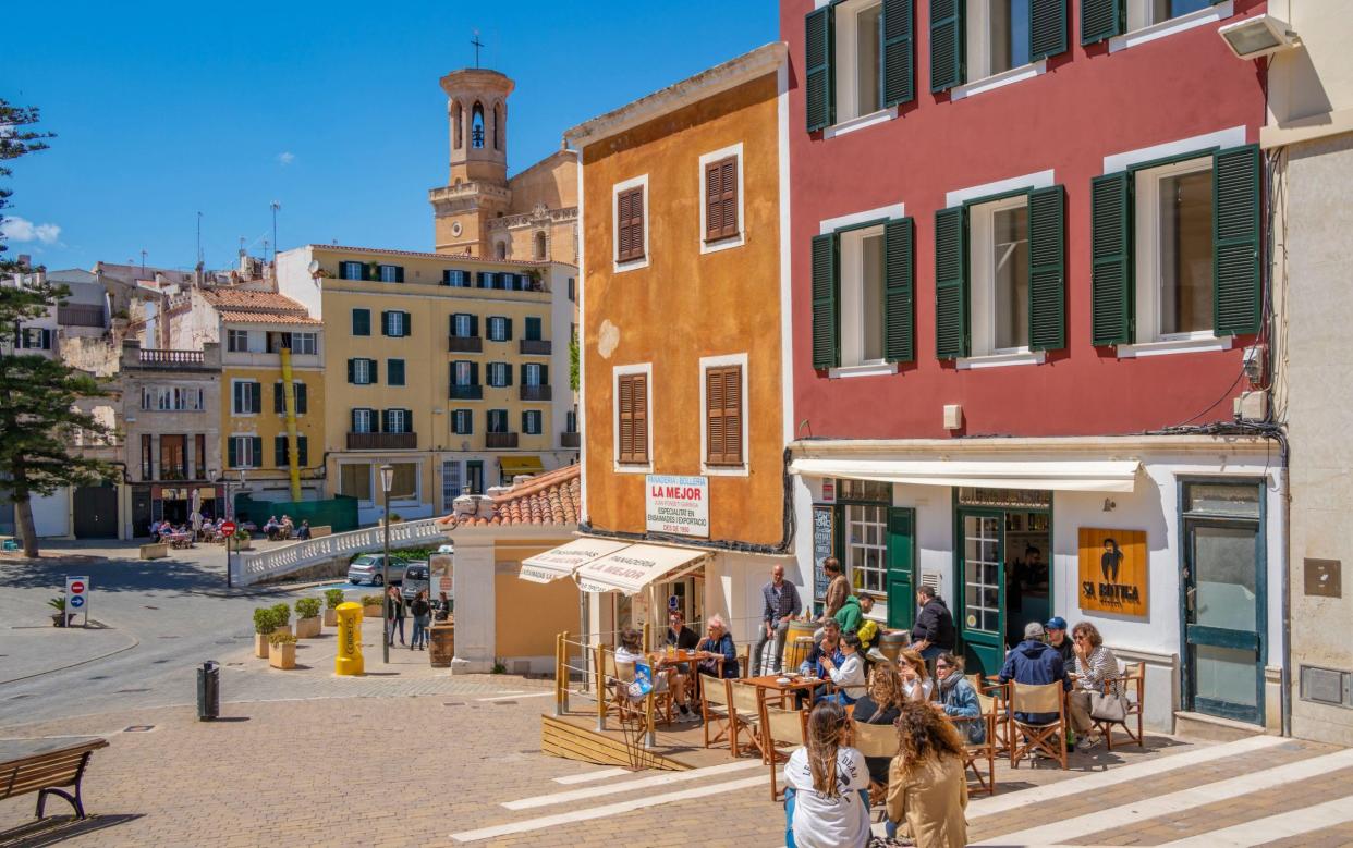 View of Santa Maria de Mao Church and cafe in Placa d'Espanya, Mahon, Menorca