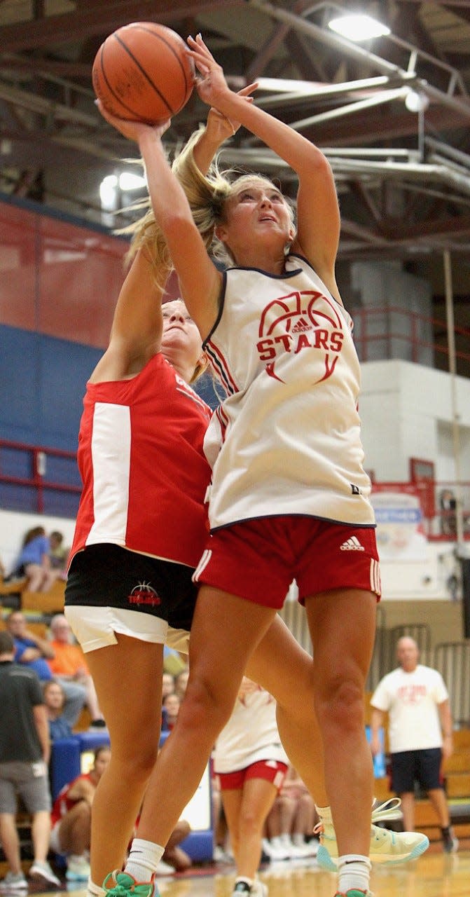 BNL junior Chloe Spreen is hammered on a shot attempt Thursday. Spreen scored 24 points as the Lady Stars downed Center Grove.