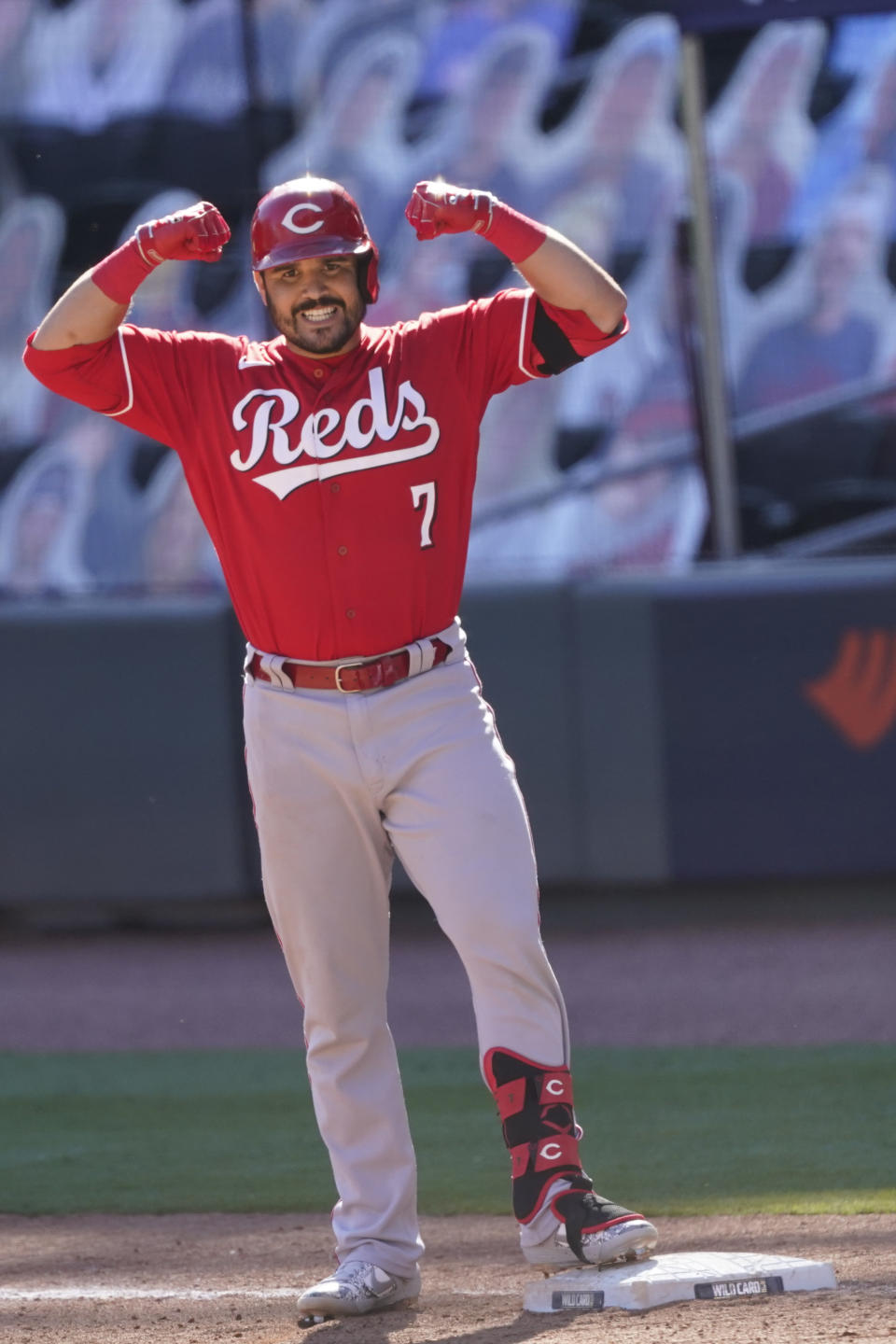 Cincinnati Reds Eugenio Suarez (7) celebrates a base hit in 13th inning against the Atlanta Braves during Game 1 of a National League wild-card baseball series, Wednesday, Sept. 30, 2020, in Atlanta. (AP Photo/John Bazemore)