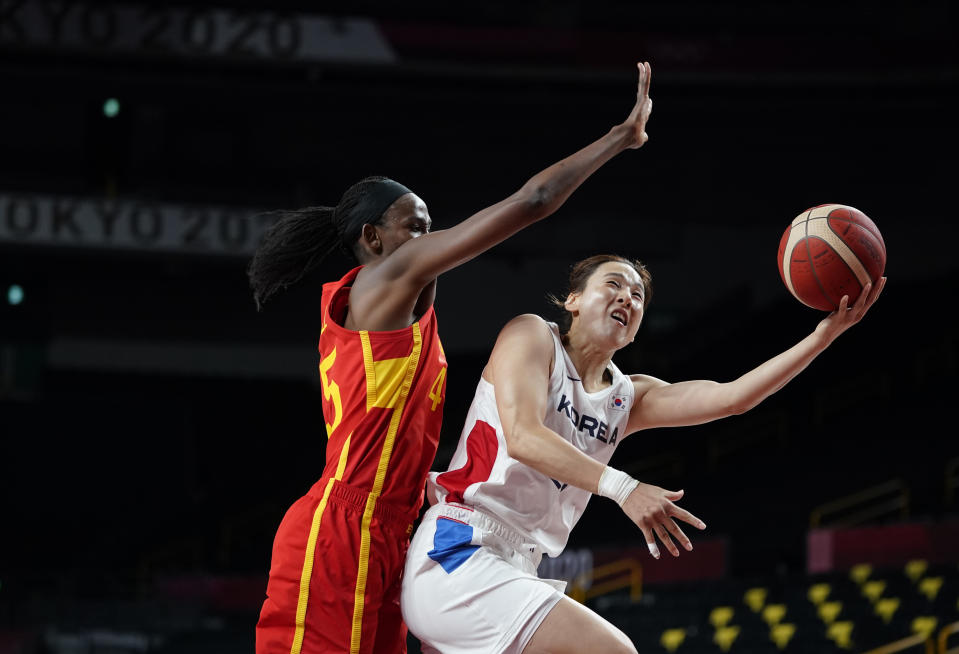 South Korea's Danbi Kim, right, drives to the basket past Spain's Astou Ndour during women's basketball preliminary round game at the 2020 Summer Olympics, Monday, July 26, 2021, in Saitama, Japan. (AP Photo/Charlie Neibergall)