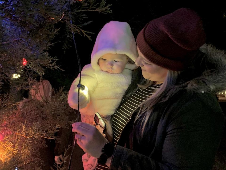 North Augusta residents Kadie Allen, right, and six-month-old Emma Wilson enjoy the lights of the North Augusta Christmas tree at John C. Calhoun Park.