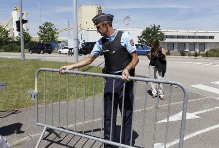 A French Gendarme blocks the access road to the Saint-Quentin-Fallavier industrial area, near Lyon, France, June 26, 2015. REUTERS/Emmanuel Foudrot