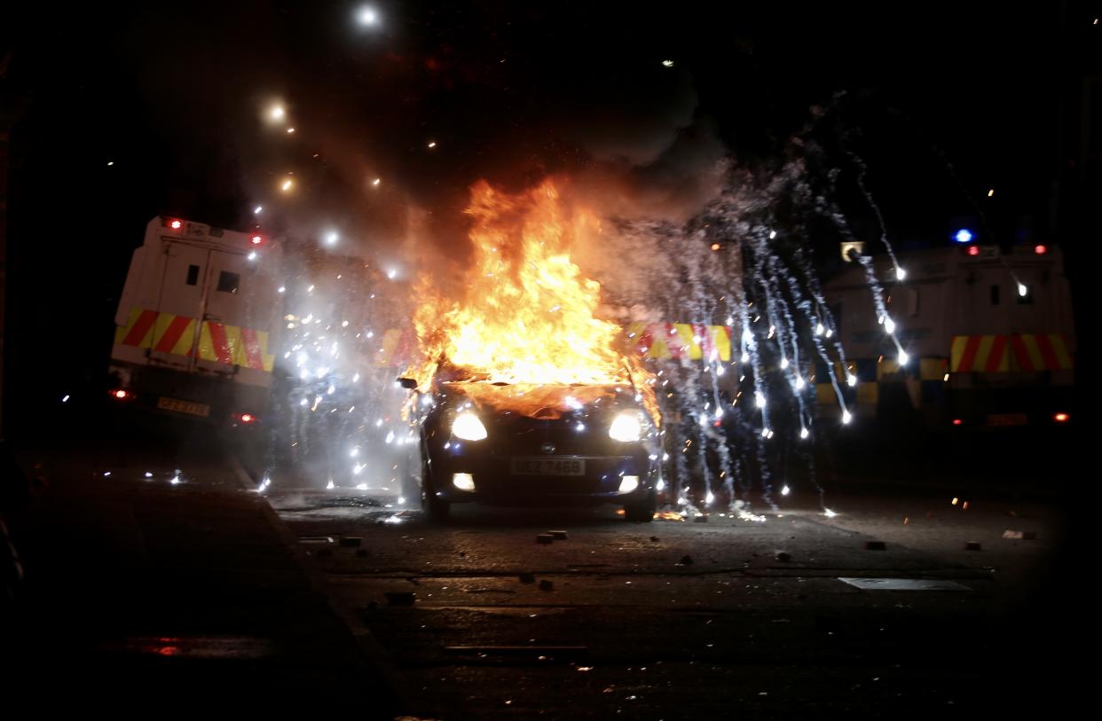 BELFAST, NORTHERN IRELAND - APRIL 09: Flames and smoke rise from car set a fire during protests as rioters hurled petrol bombs, fireworks and stones at police amid unrest since Wednesday, in Belfast, Northern Ireland on April 09, 2021. â¨The unrest started when some Sinn Fein members attended a crowded funeral on top of tensions caused by Brexit border arrangements, which brought checks on goods shipped between Northern Ireland and the rest of the UK. â¨Both loyalist and nationalist areas were involved in riots in west Belfast. (Photo by Hasan Esen/Anadolu Agency via Getty Images)