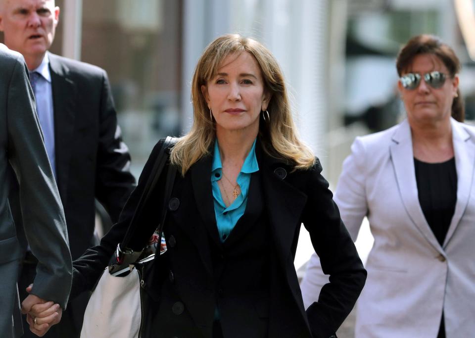 Felicity Huffman arrives at federal court in Boston to face charges in a nationwide college admissions bribery scandal. 