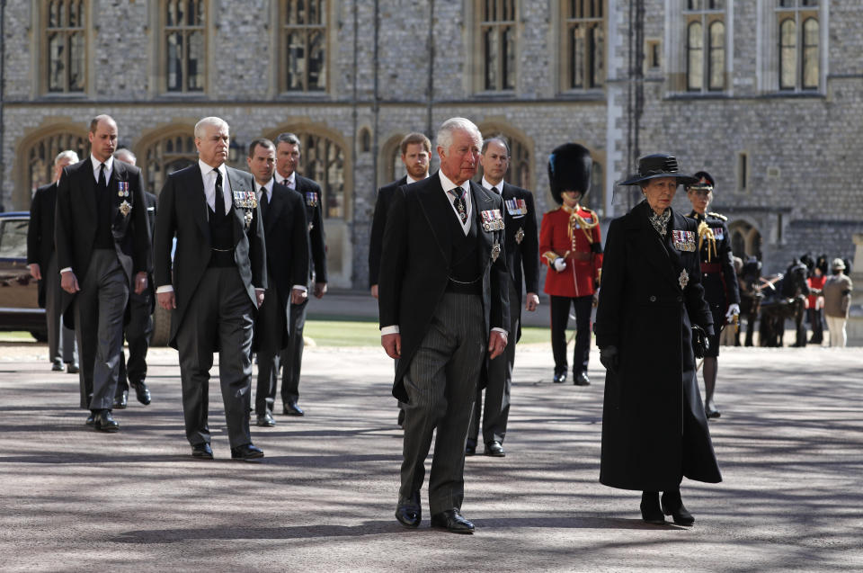 From front left, Britain's Prince Charles, Princess Anne, Prince Andrew. Prince Edward, Prince William, Peter Phillips, Prince Harry, Earl of Snowdon and Tim Laurence follow the coffin in a ceremonial procession for the funeral of Britain's Prince Philip inside Windsor Castle in Windsor, England Saturday April 17, 2021. Prince Philip died April 9 at the age of 99 after 73 years of marriage to Britain's Queen Elizabeth II. (Alastair Grant/Pool via AP)