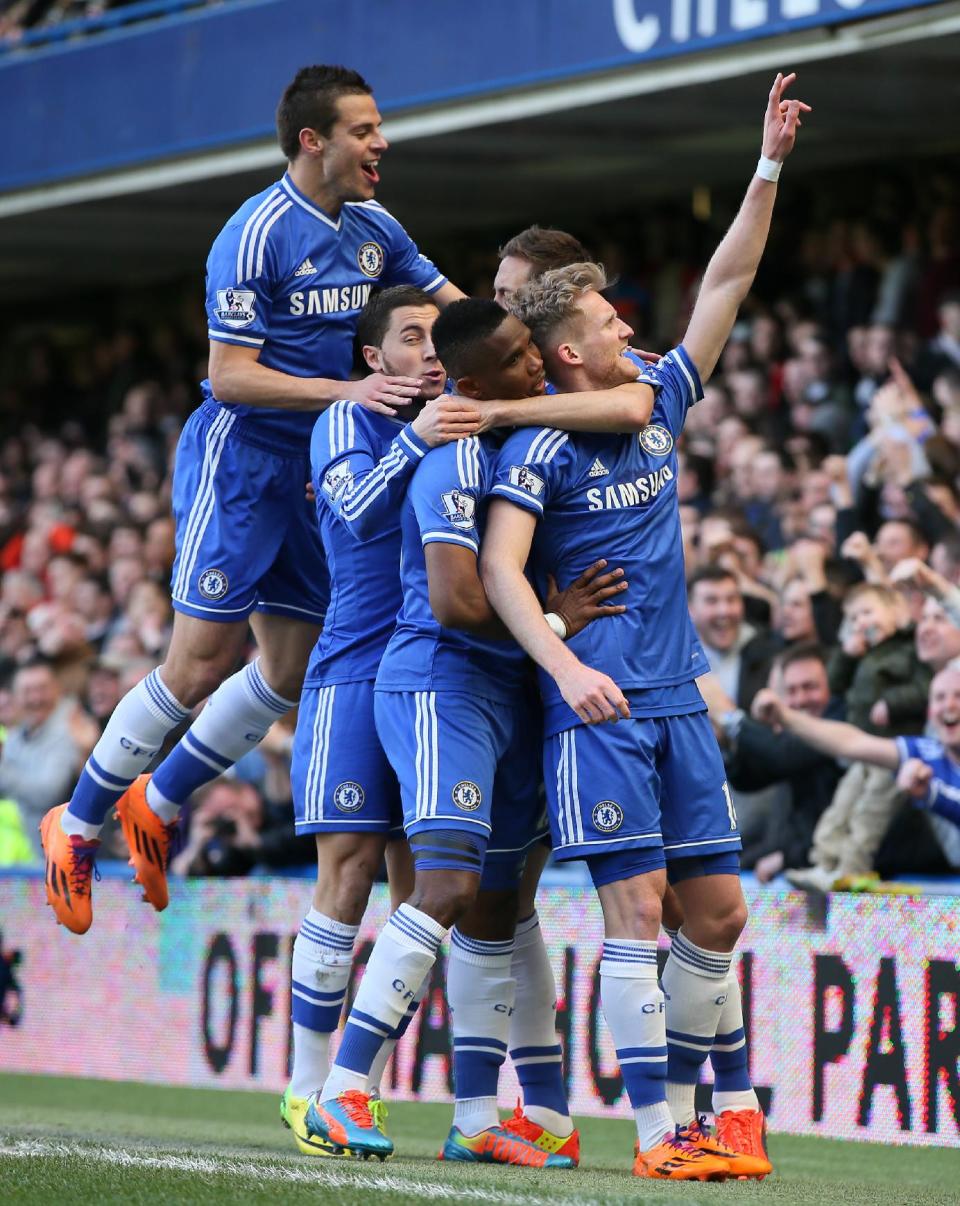 Chelsea's Andre Schuerrle, right celebrates with teammates after scoring his sides second goal during their English Premier League soccer match between Chelsea and Arsenal at Stamford Bridge stadium in London, Saturday, March 22, 2014. (AP Photo/Alastair Grant)