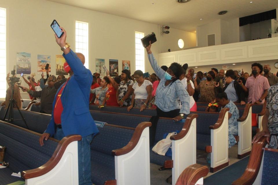 Parishioners praise the Lord during the annual Family and Friends Day service Sunday at PASSAGE Family Church.