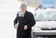 A man arrives at the funeral home prior to the visitation for Vito Rizzuto, head of the infamous Rizzuto crime family, in Montreal December 29, 2013. Rizzuto died of natural causes in a hospital on December 23, 2013. REUTERS/Christinne Muschi (CANADA - Tags: CRIME LAW OBITUARY SOCIETY)
