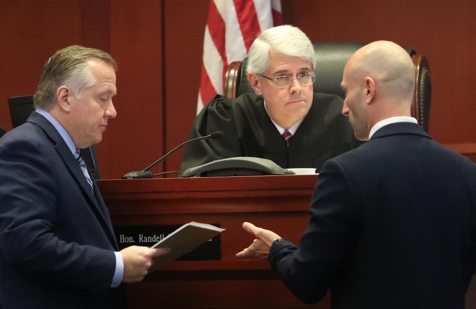 Assistant public defender Larry Avallone and Assistant State Attorney Mark Interlicchio speak with Judge Randell Rowe III, Tuesday, March 5, 2024, during Michael Williams' second-degree murder trial in the killing of his ex-wife, Marsha Williams, and her son, Robert Adams, at the Volusia County Courthouse in DeLand.