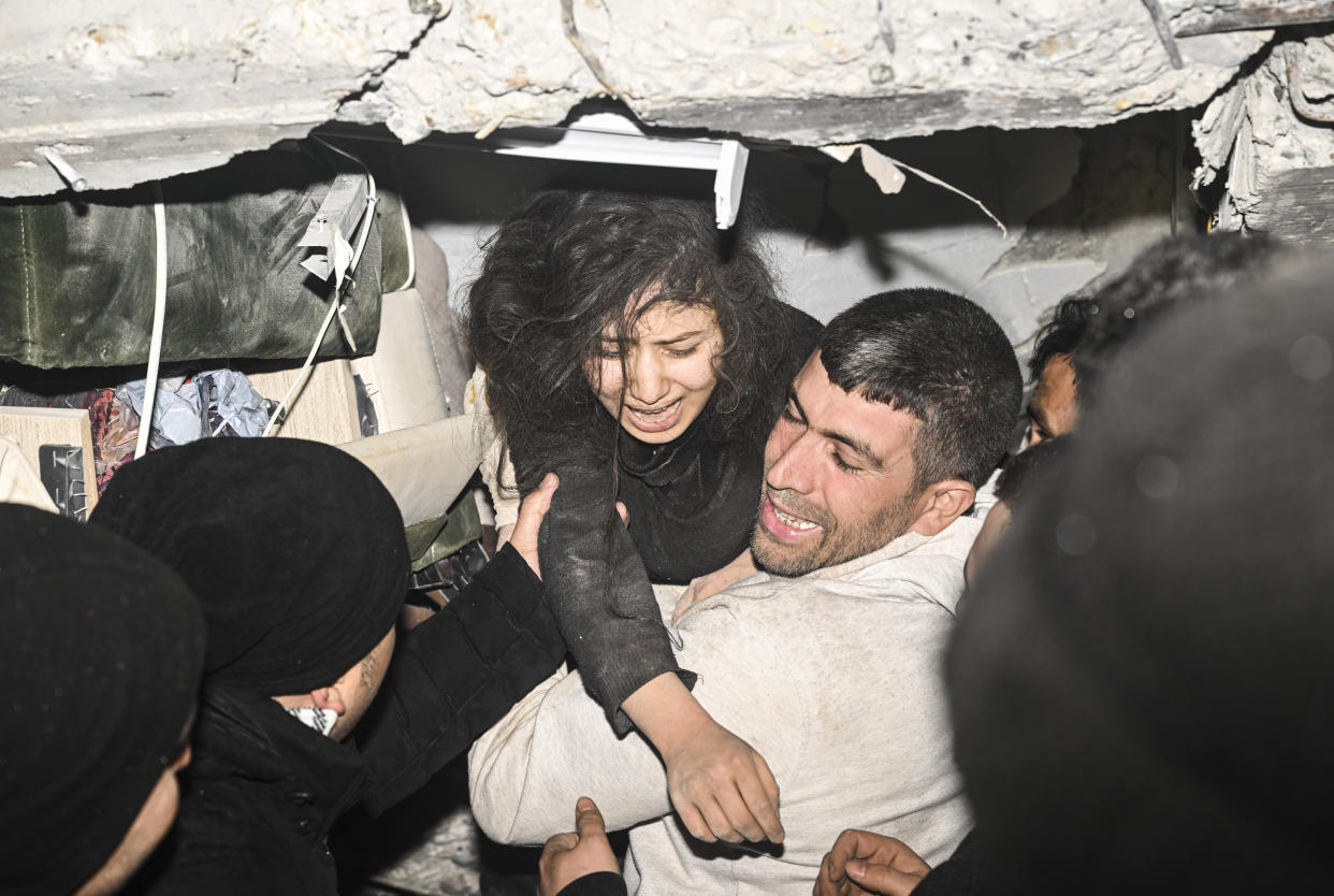 Rescuers pull a 17-year-old girl from a collapsed building.