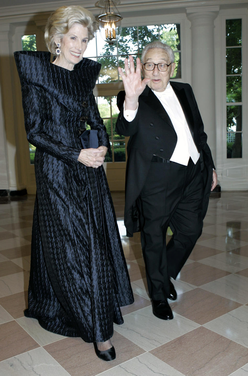 FILE - Henry Kissinger, right, and his wife Nancy walk through the Booksellers Area as they arrive for the State Dinner in honor of Queen Elizabeth II and her husband Prince Philip, May 7, 2007, at the White House in Washington. Former Secretary of State Kissinger, the diplomat with the thick glasses and gravelly voice who dominated foreign policy as the United States extricated itself from Vietnam and broke down barriers with China, died Wednesday, Nov. 29, 2023. He was 100. (AP Photo/Haraz N. Ghanbari, File)