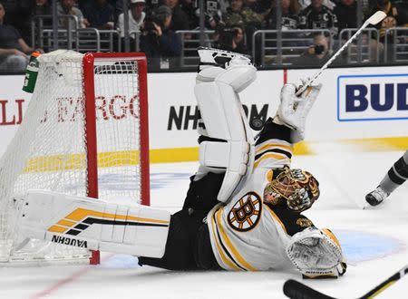 February 16, 2019; Los Angeles, CA, USA; Boston Bruins goaltender Tuukka Rask (40) blocks a shot against Los Angeles Kings left wing Alex Iafallo (19) during the second period at Staples Center. Mandatory Credit: Gary A. Vasquez-USA TODAY Sports