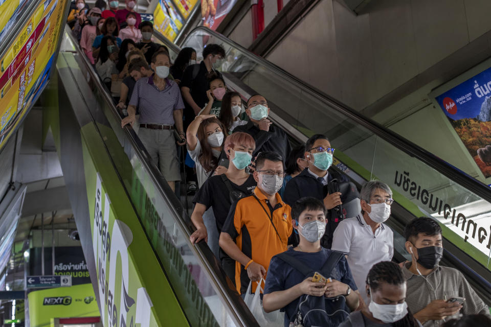 Commuters wear face masks to protect themselves from new virus in Bangkok, Thailand, Thursday, Feb. 6, 2020. A viral outbreak that began in China has infected more than 28,200 people globally. Thailand has 25 cases as of Thursday. (AP Photo/Gemunu Amarasinghe)