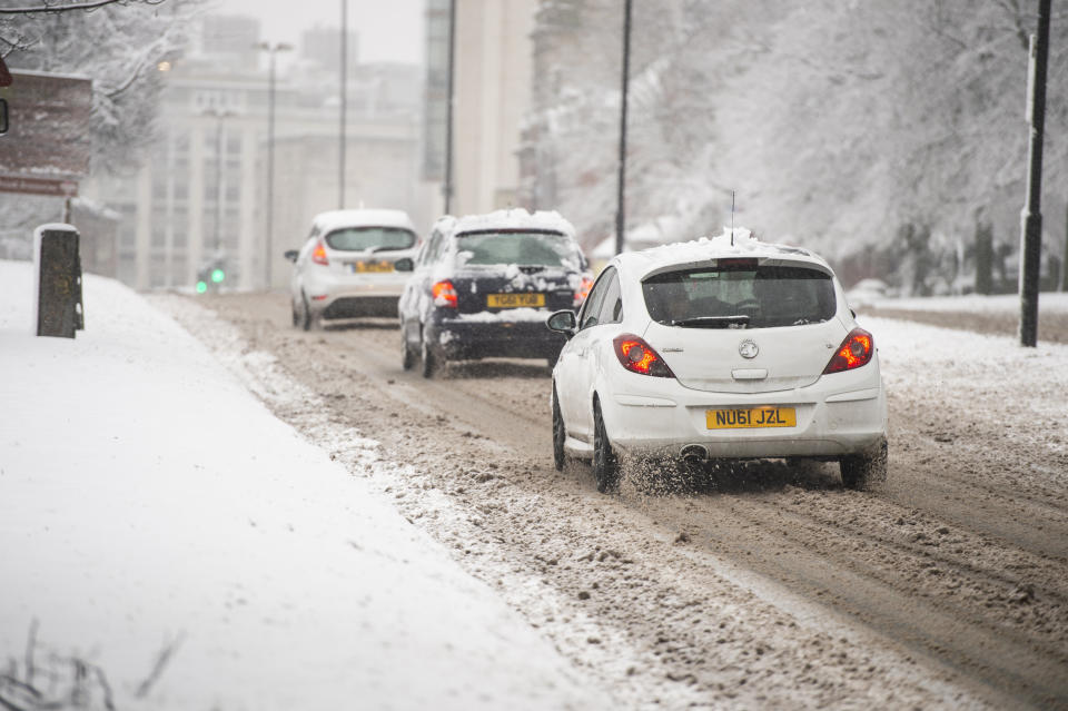 Cars work their way through treacherous driving conditions in Leeds.