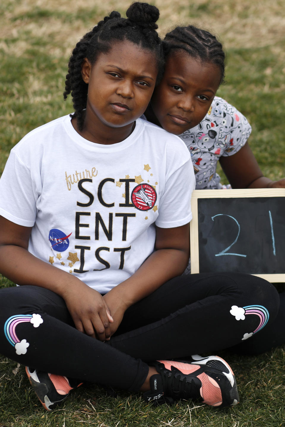 Khamani Brown, 10, left, and her cousin Jisele Williams, 10, both of Washington, pose for a portrait with a chalkboard of their ages in 2030, the point where the globe would be stuck on a path toward what scientists call planet-changing dangerous warming, Friday, March 15, 2019, during a climate change rally of students in Washington. "We wanted to come because it's important that young people come out and support the change," says Brown, "to show we are up to the challenge and can do the same things that adults can." From the South Pacific to the edge of the Arctic Circle, students are skipping classes to protest what they see as the failures of their governments to take tough action against global warming. The 'school strikes' on Friday were inspired by 16-year-old Swedish activist Greta Thunberg and are taking place in over 100 countries. (AP Photo/Jacquelyn Martin)