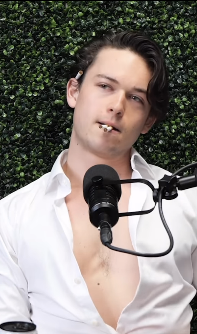 Jack as Cole with two cigarettes in his mouth and one behind his ear. His shirt is also halfway unbuttoned