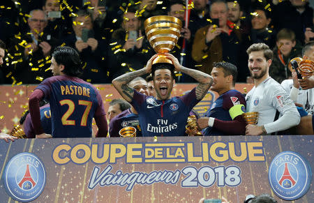 Soccer Football - Coupe de la Ligue Final - Paris St Germain vs AS Monaco - Matmut Atlantique Stadium, Bordeaux, France - March 31, 2018 Paris Saint-Germain's Dani Alves lifts the trophy as his team celebrates after victory REUTERS/Regis Duvignau