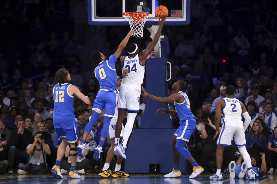 Kentucky forward Oscar Tshiebwe (34) attempts a layup during the second half of an NCAA college basketball game against UCLA in the CBS Sports Classic, Saturday, Dec. 17, 2022, in New York. The Bruins won 63-53. (AP Photo/Julia Nikhinson)