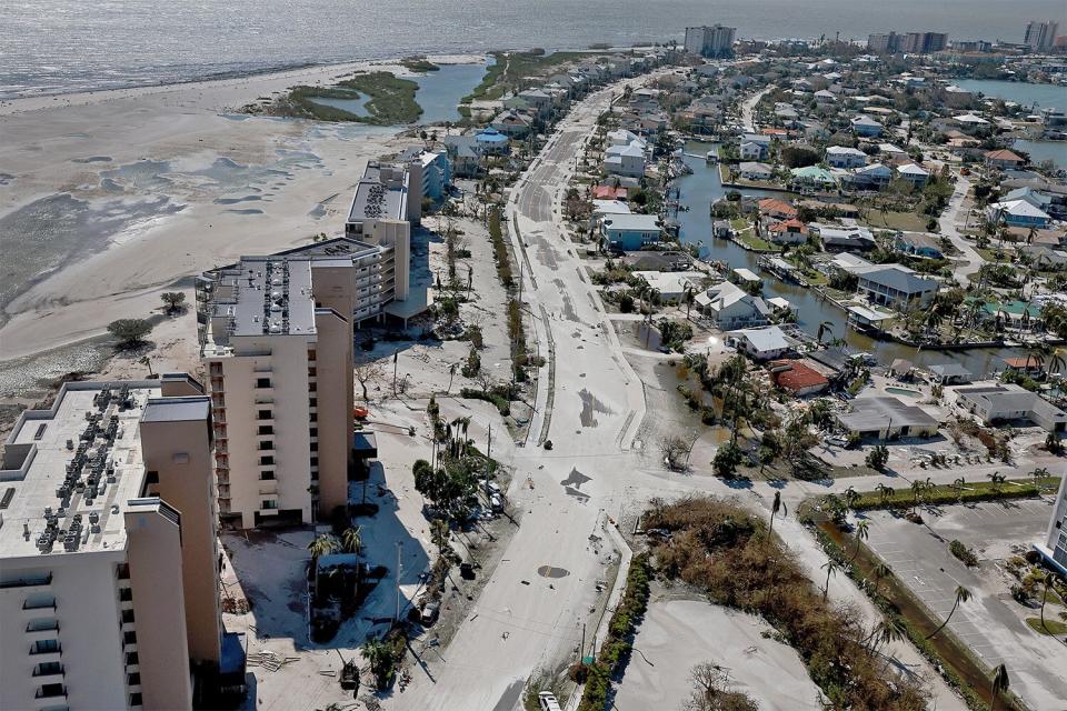 FORT MYERS BEACH, FLORIDA - SEPTEMBER 29: In an aerial view, beach sand covers a roadway after Hurricane Ian passed through the area on September 29, 2022 in Fort Myers Beach, Florida. The hurricane brought high winds, storm surge and rain to the area causing severe damage. (Photo by Joe Raedle/Getty Images)