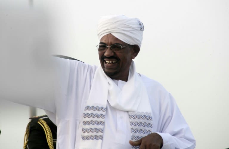 Sudanese President Omar al-Bashir waves as he arrives in Khartoum from Johannesburg, on June 15, 2015