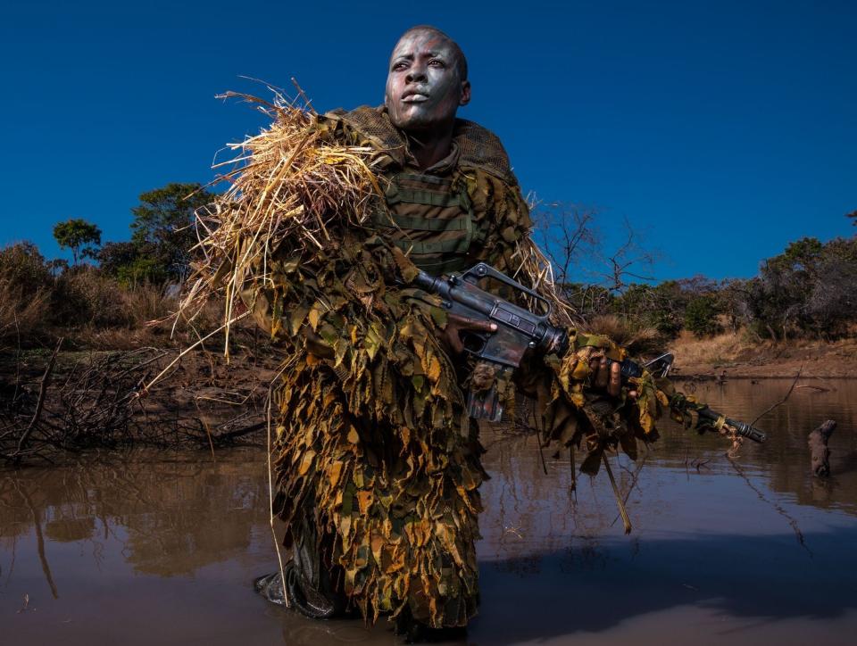 Petronella Chigumbura, a member of the Akashinga – a nonprofit, all-female anti-poaching unit – practices reconnaissance techniques in the Zimbabwean bush. (Picture: National Geographic/Brent Stirton)