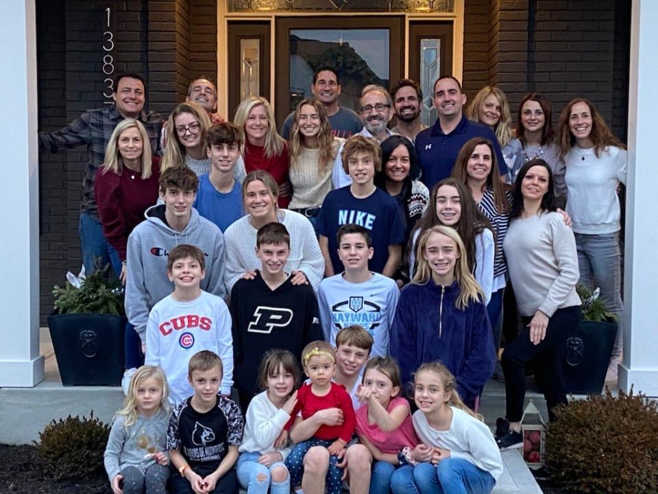 Paul Ayers, in the center of the top row, and his family.